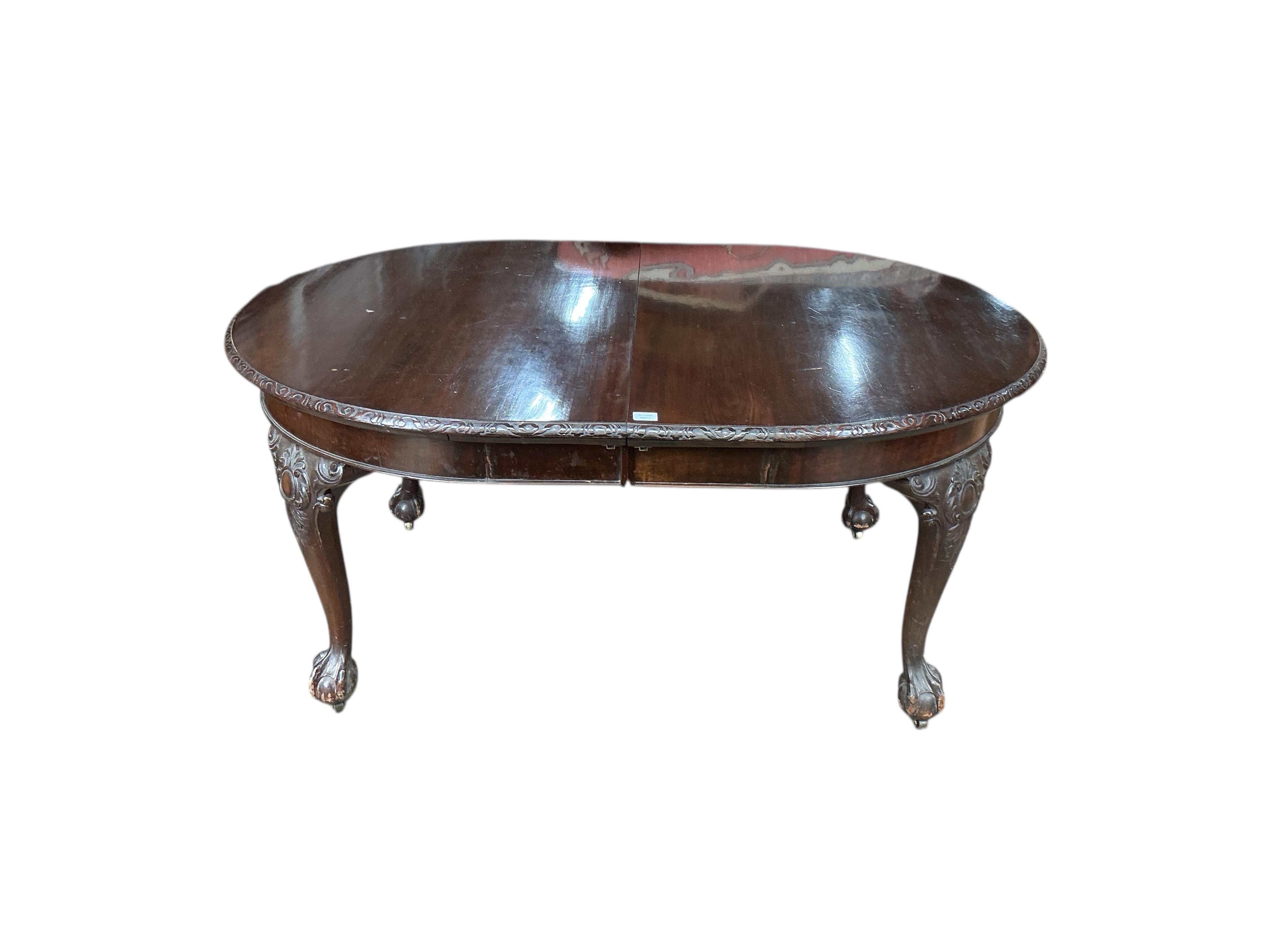 An early 20th century Chippendale Revival mahogany extending dining table, on cabriole legs with claw and ball feet, width 340cm extended, three spare leaves, depth 120cm, height 77cm